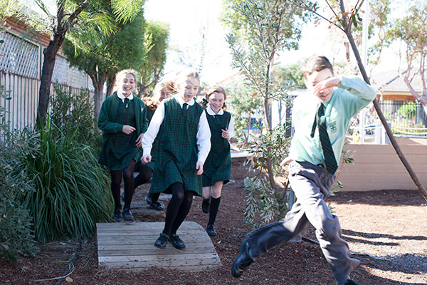 St Francis Xavier Catholic Primary School Ashbury - students running through courtyard